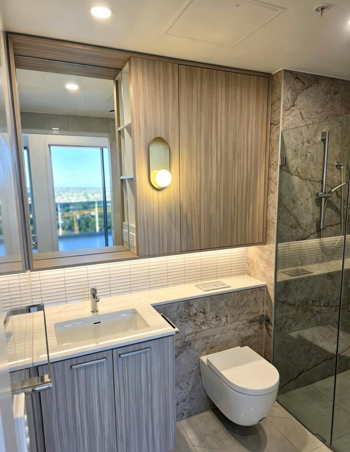 Ensuite vanity and storage with city view in a high-rise apartment