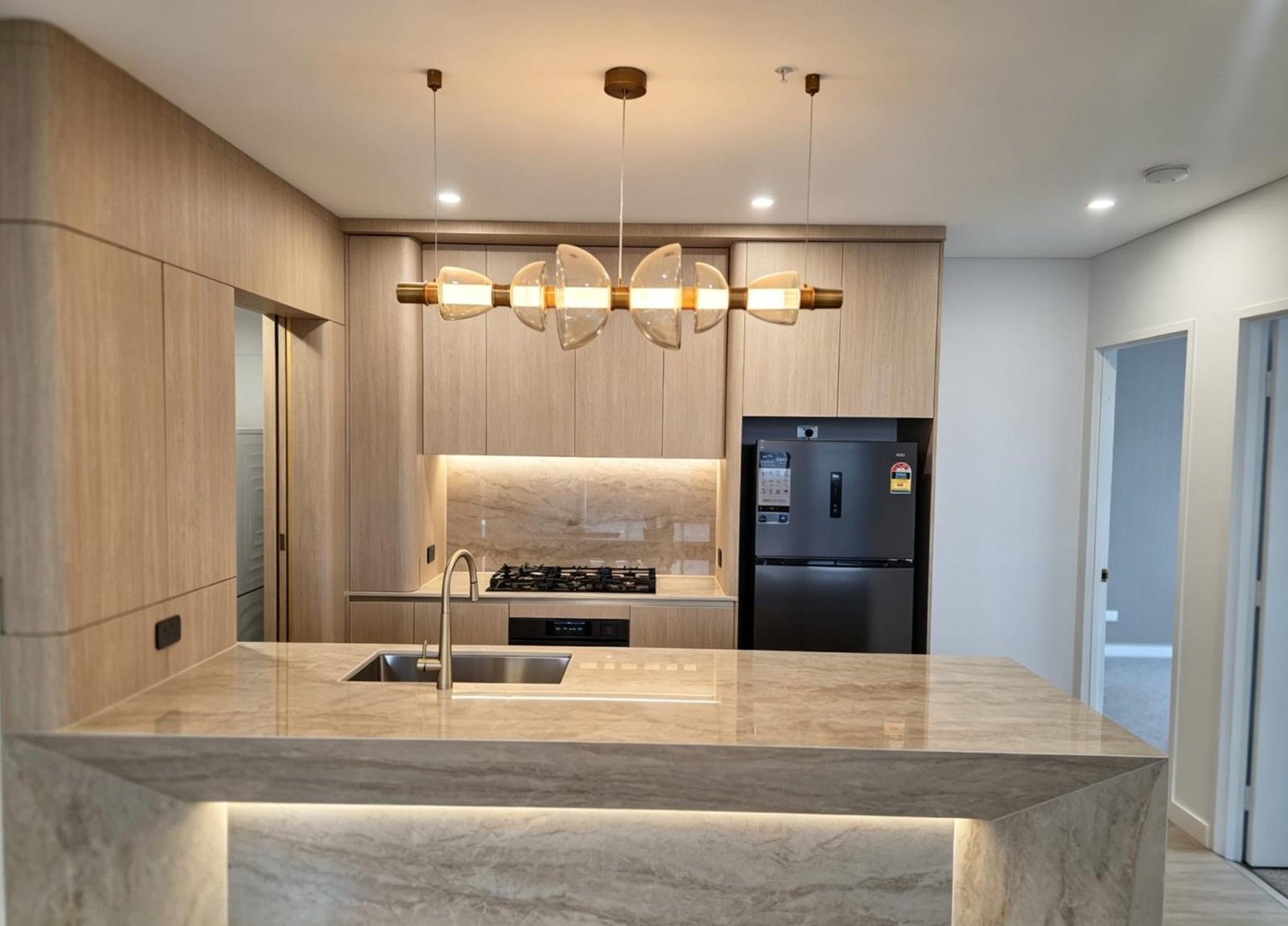 Stone-island apartment kitchen with timber-look joinery, Meriton Epping